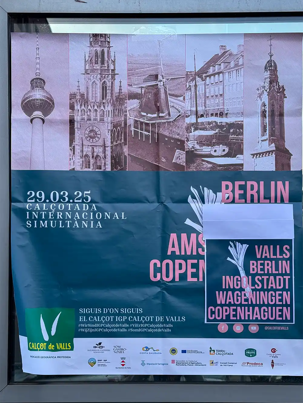 Plakat mit Wahrzeichen von Städten und Veranstaltungshinweisen für die Calçotada Internacional Simultània am 29. März 2025.